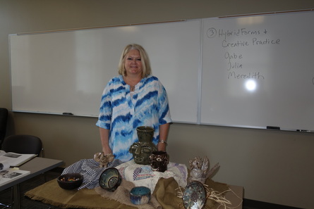 New College Life Track student Karen Burns displaying her pottery together with the work by folk potter Jerry Brown that inspired her.